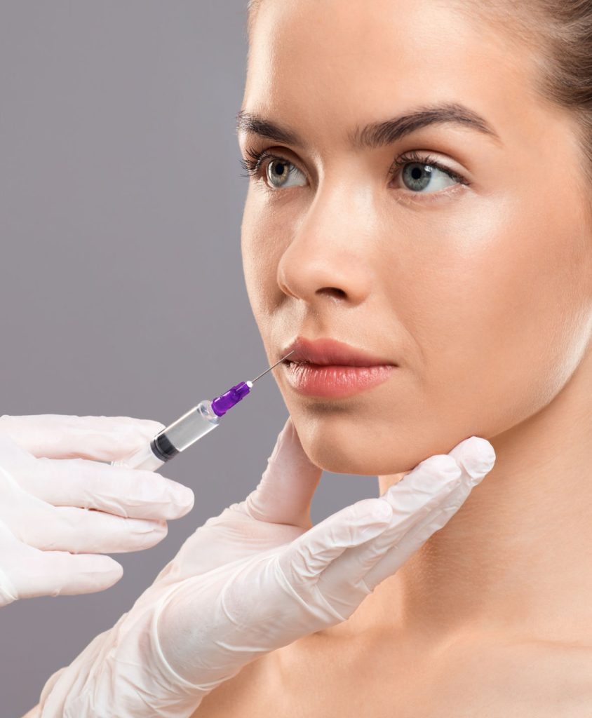 Neurotoxins injection for young lady over grey studio background